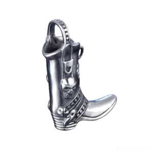 Cowboy boot pendant side profile displaying detailed skull engravings and polished silver stainless steel finish