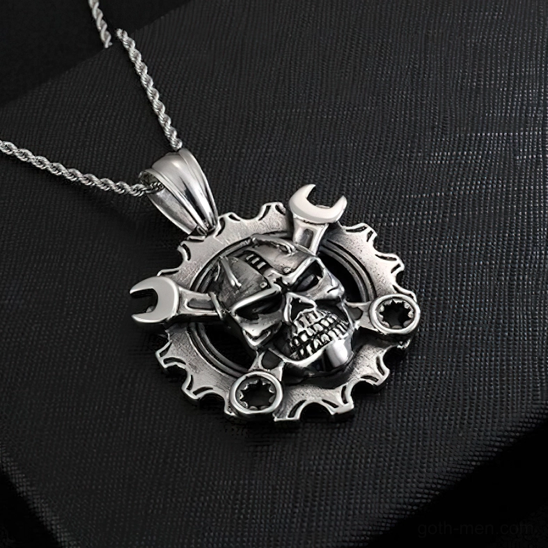 Mechanical skull necklace with twisted stainless steel chain on black fabric background vintage aesthetic