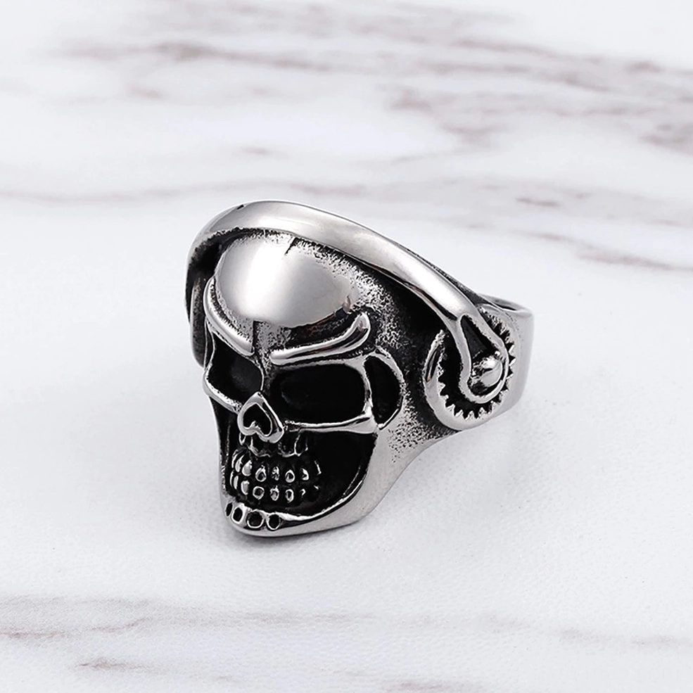 Headphone skull punk ring three-quarter front view, smooth polished skull crown with matte textured vintage silver sides