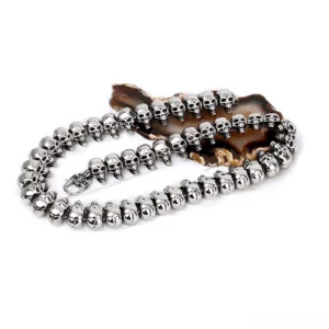 Silver tone skull bead necklace coiled display showing detailed skull craftsmanship and chain construction