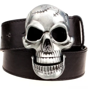 Statement skull metal buckle on black leather gothic belt, top-down view showing intricate stitched skull design