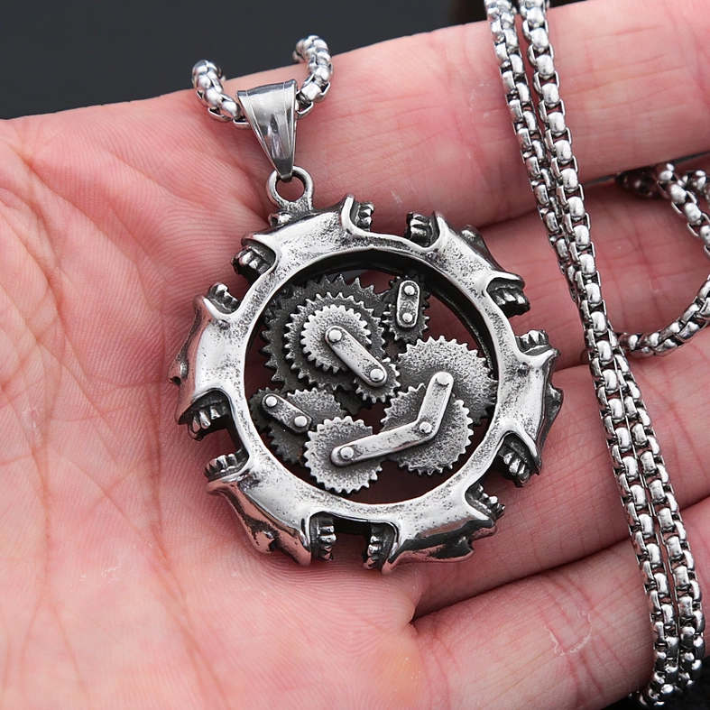 Mechanical skull pendant worn on hand showing actual size reference and antiqued silver stainless steel link chain