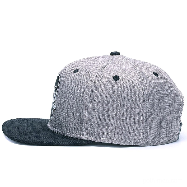 Skull ride hard gothic snapback cap left side profile, highlighting the adjustable plastic buckle closure and structured flat brim design