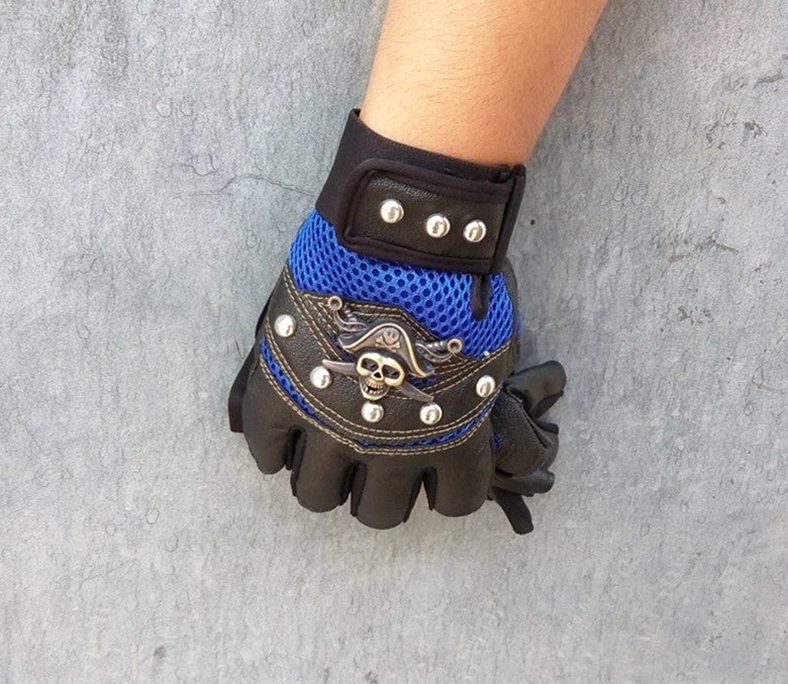 Premium synthetic leather skull rivet gloves with embossed pirate skull emblem and polished metal rivets close-up
