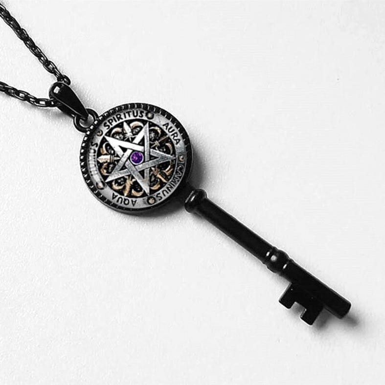 Overhead close-up detail of black Key of Solomon pendant showing engraved protective text and pentagram geometry