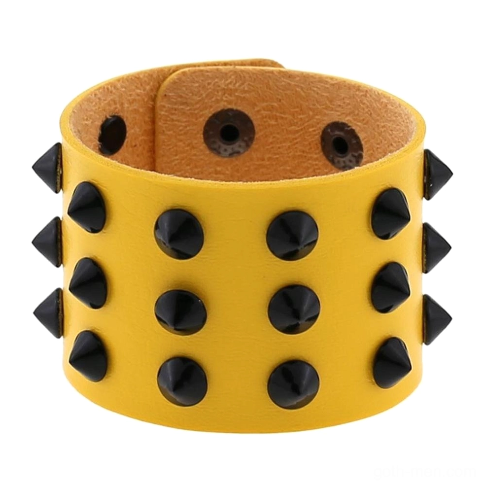 Close-up detail of spike studded bracelet showing textured vegan leather and individual cone spike craftsmanship