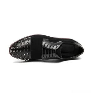 Close-up side view of spiked gothic derby shoe showing detailed metal spike studs and toe cap construction