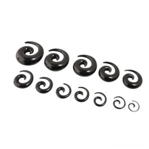 Assorted black spiral taper stretchers, organized by size from large to small, studio product photography
