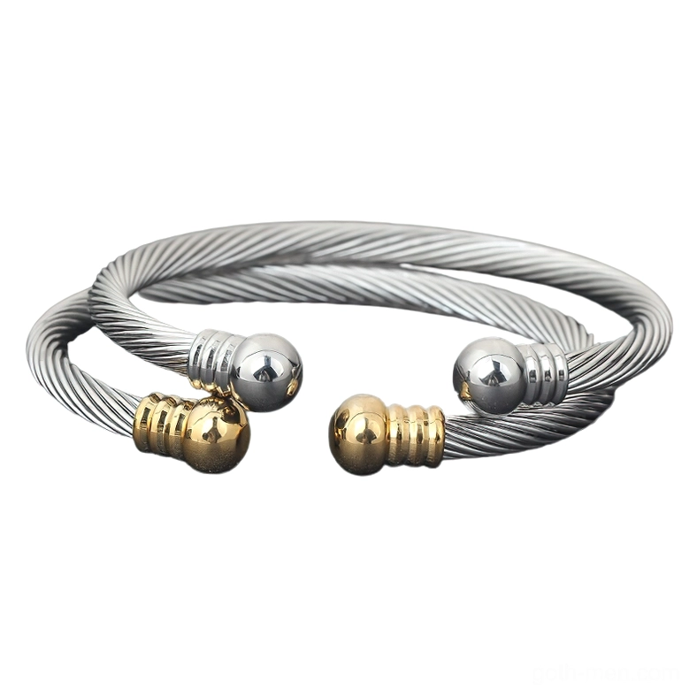 Double-strand twisted cable open cuff bracelets stacked, mixed metal ends flat lay view