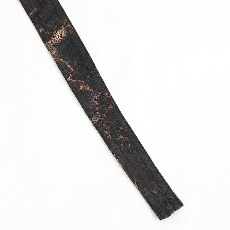 Close-up flat lay of steampunk bandana fabric tail strap showing marbled black-bronze weave and elongated shape