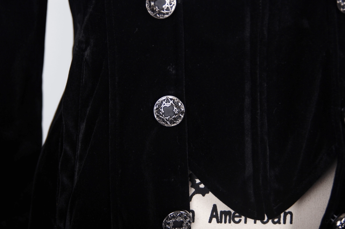Embossed round metal buttons on black velvet gothic tailcoat with partial hem and fastening detail