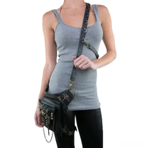 Female model wearing black steampunk drop leg bag as crossbody shoulder bag, adjustable strap with zippered pocket detail