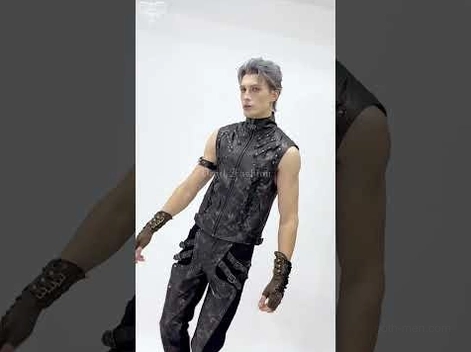 Full body shot of steampunk fingerless gloves worn with gothic vest outfit, male model in studio setting