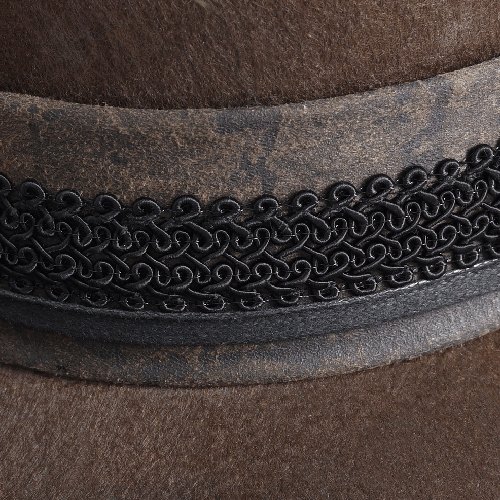 Brown acrylic steampunk gothic hat close-up of feather and brass gear embellishment