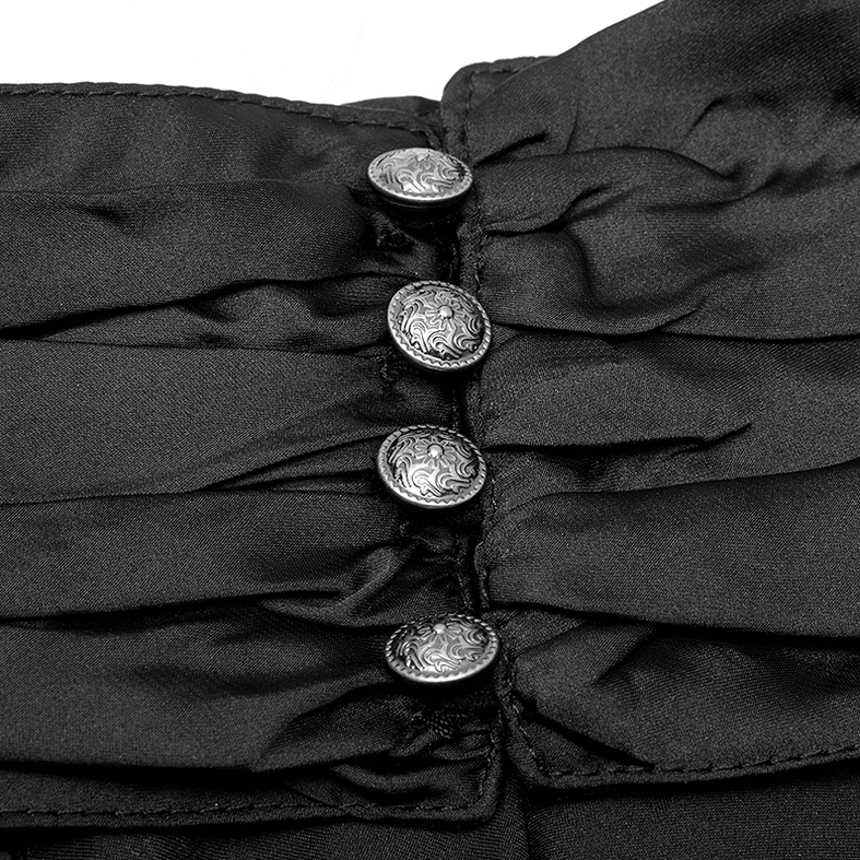 Black steampunk shirt front placket close-up showing ornate embossed silver buttons, pleated satin fabric, and layered ruffles