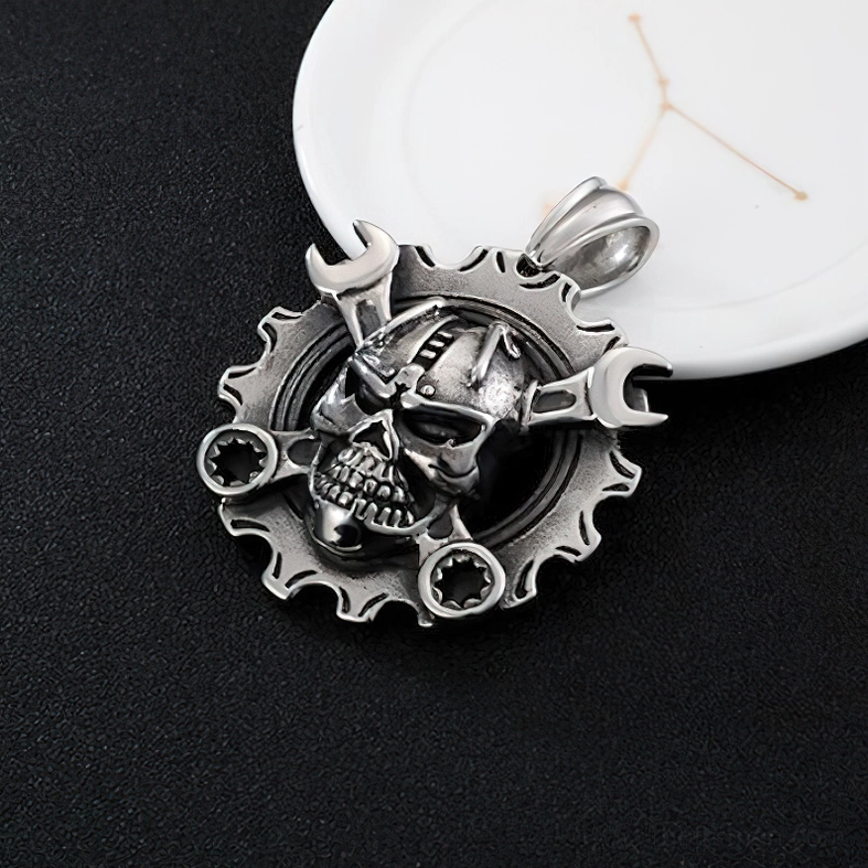 Angled view of steampunk skull gear pendant on black background showing industrial punk design and wrench frame