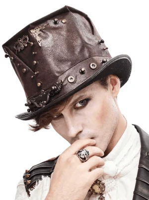 Brown steampunk top hat with skull metal rivets worn by male model, three-quarter front view showing ornate brass trim and dark gothic aesthetic