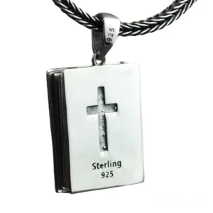 Front flat view of sterling silver religious bible locket pendant displaying embossed cross and 925 silver hallmark stamp