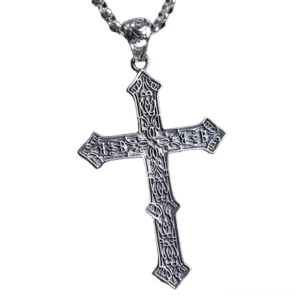 Detailed front perspective of silver skull cross pendant showing intricate relief carving and vintage patina finish for gothic necklace