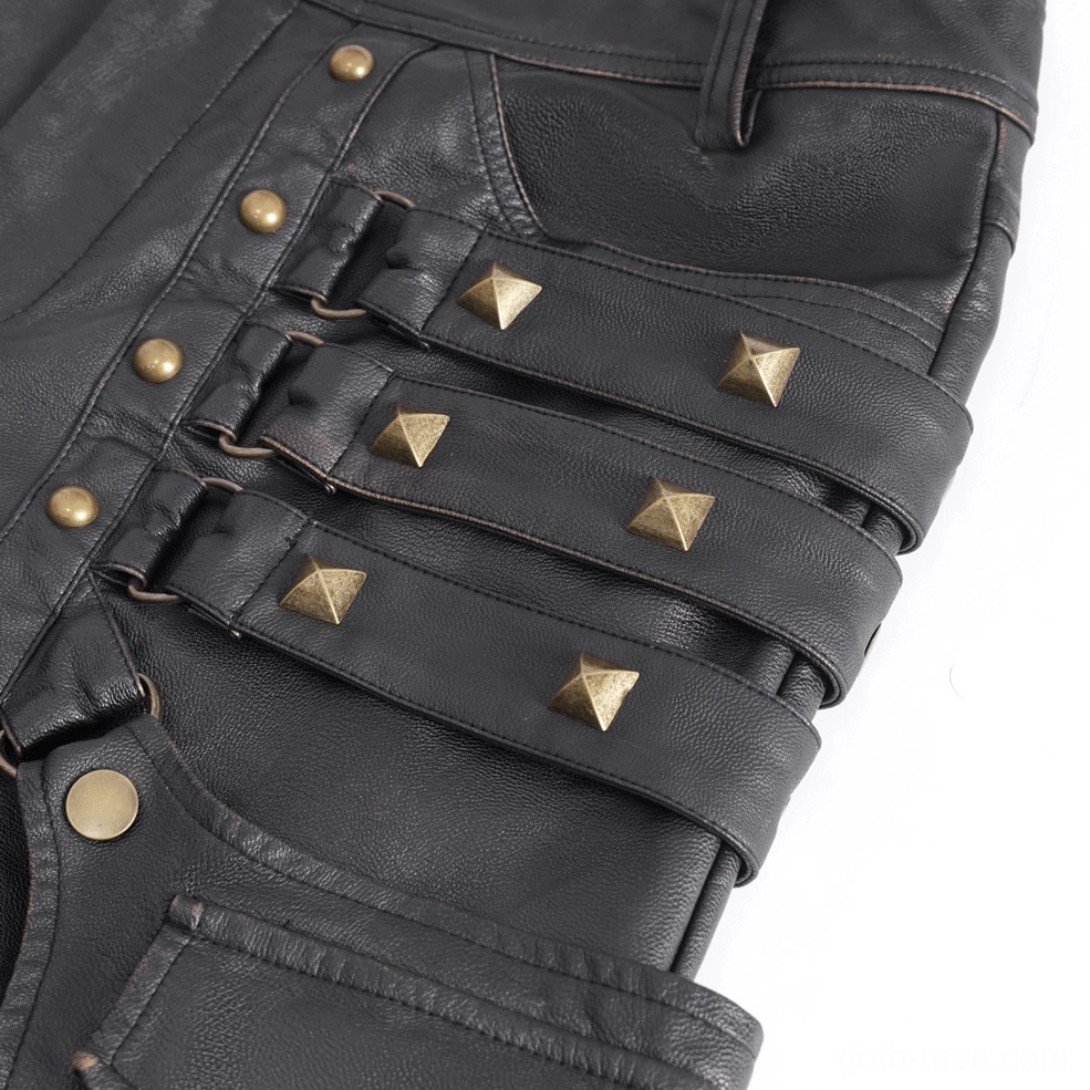 Macro photography of pyramid bronze studs and adjustable leather strap detail on men's gothic cargo pants