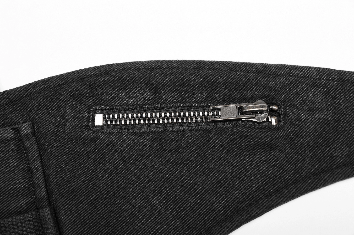 Zipper detail of black canvas tactical harness, silver metal slide closure on side pocket