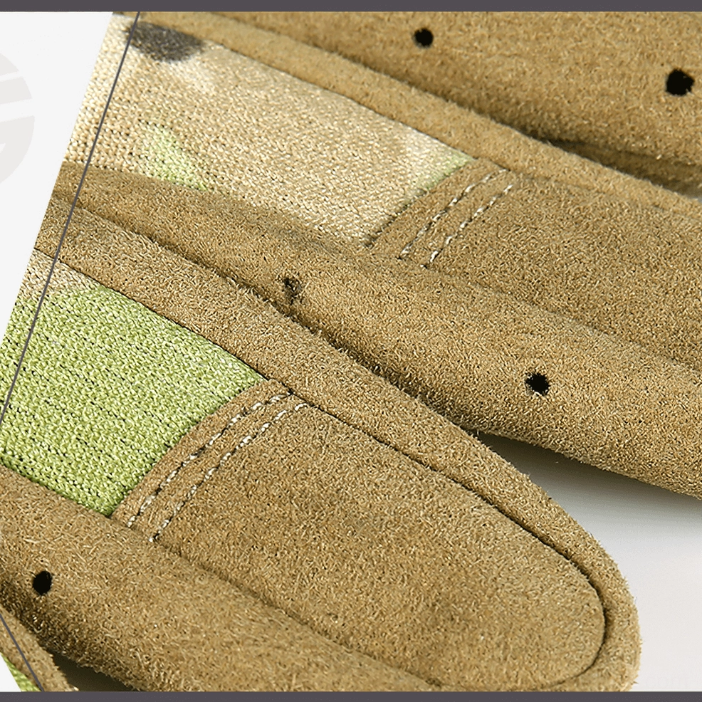 Close-up of tactical glove fingertips showing stitched seams and ventilation hole engineering