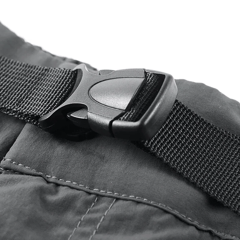 Close-up detail of tactical shorts adjustable waist buckle assembly with nylon webbing and plastic quick-release buckles