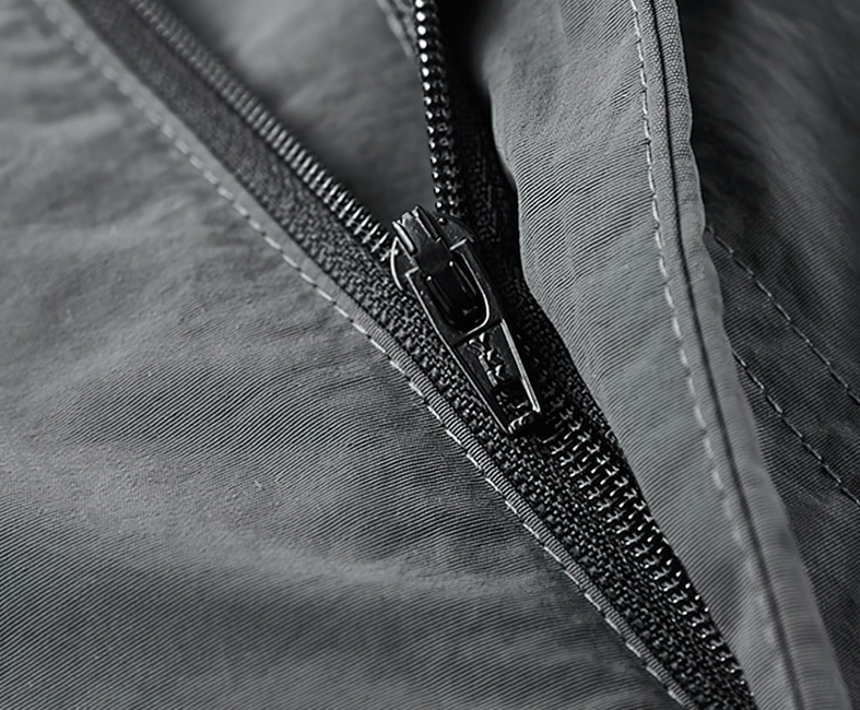 Close-up front view detail of tactical shorts zipper seam with durable nylon fabric and precise topstitching