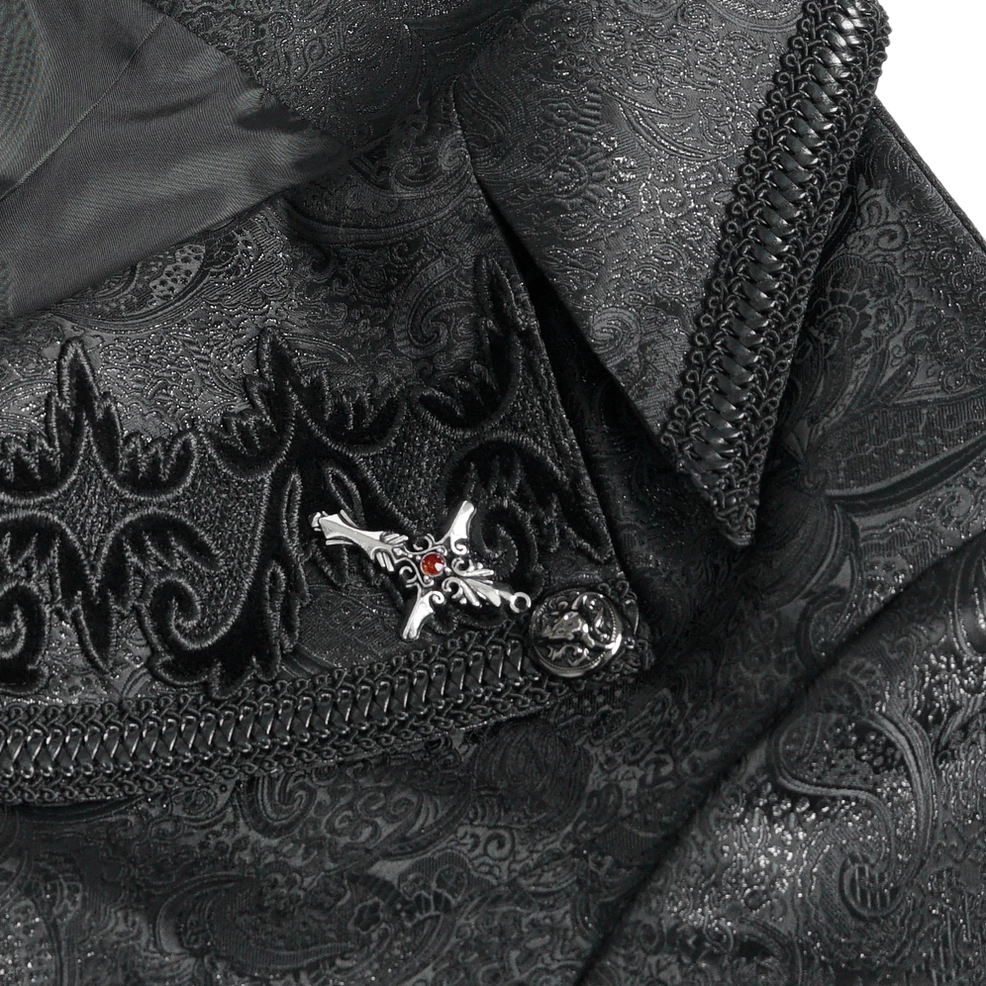 Close-up detail of gothic tailcoat fabric and hardware - embossed paisley brocade pattern, cross brooch, and stitch trim on dark studio background