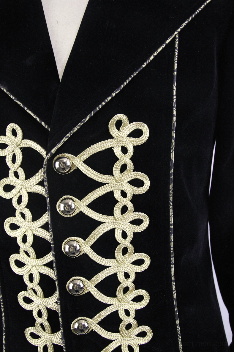 Close-up of front closure showing gold lace-up embroidery and metal snap buttons on black velvet coat