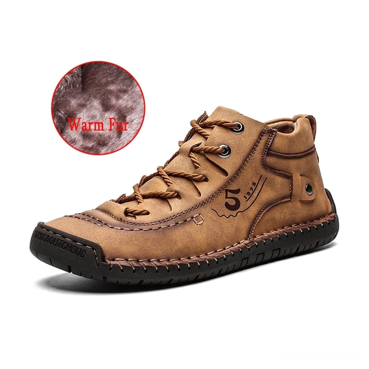 Tan split leather gothic boots with visible fur lining and embroidered side logo detail