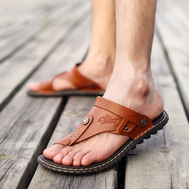 Close-up foot view man wearing tan split leather gothic sandals textured insole detail