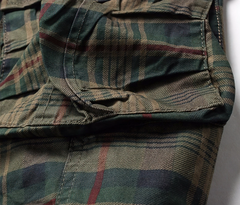Close-up of wrinkled tartan plaid fabric texture showing construction details on side panel