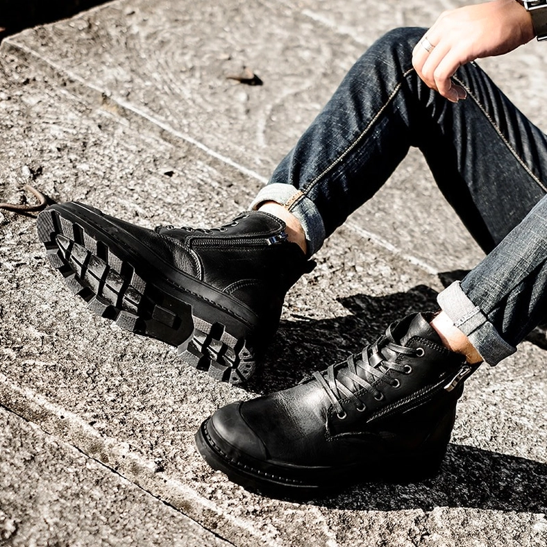Close-up detail of taupe gothic combat boot leather finish and construction with side zipper mechanism