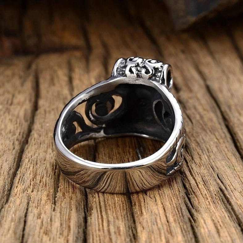 Inner side view of Thor's Hammer gothic ring on wooden table showing polished smooth inner surface and hollow carved outer Nordic design