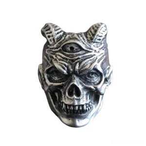 Frontal close-up of three-eyed demon skull gothic ring showing sharp fangs, third eye, and horned design
