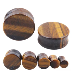Yellow tiger's eye stone ear gauges in multiple sizes displayed on white background - gothic flesh tunnels with natural golden-brown striations