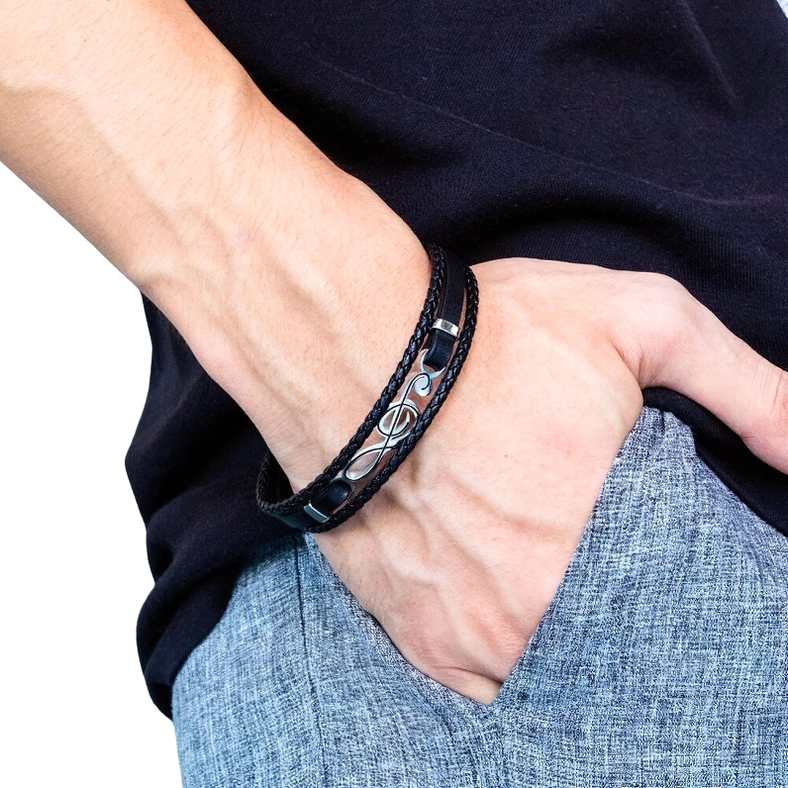 Men's treble clef leather bracelet worn on male arm model showing side perspective view with casual daily outfit background gothic alternative fashion styling