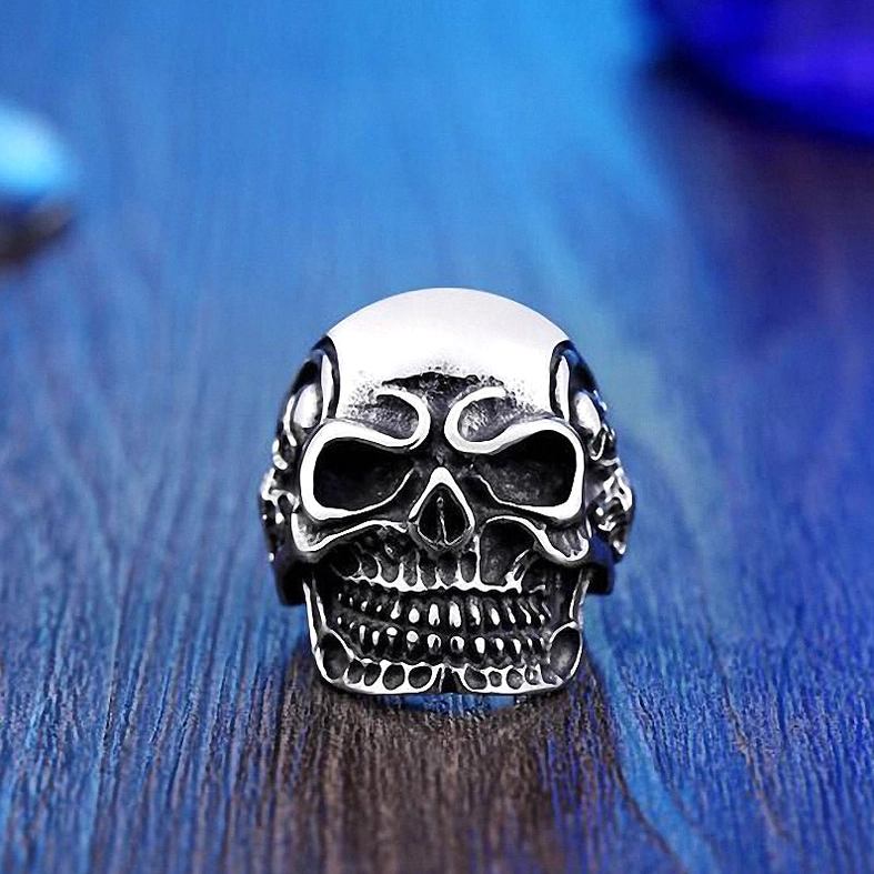 Triple skull gothic ring angled view showing skull details and band craftsmanship