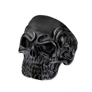 Matte black stainless steel triple skull gothic ring with carved skull details - studio front view