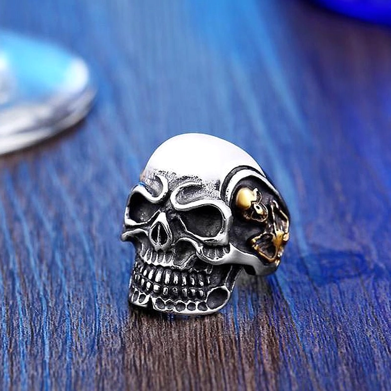 Triple skull gothic ring front facing display showing skull hierarchy composition