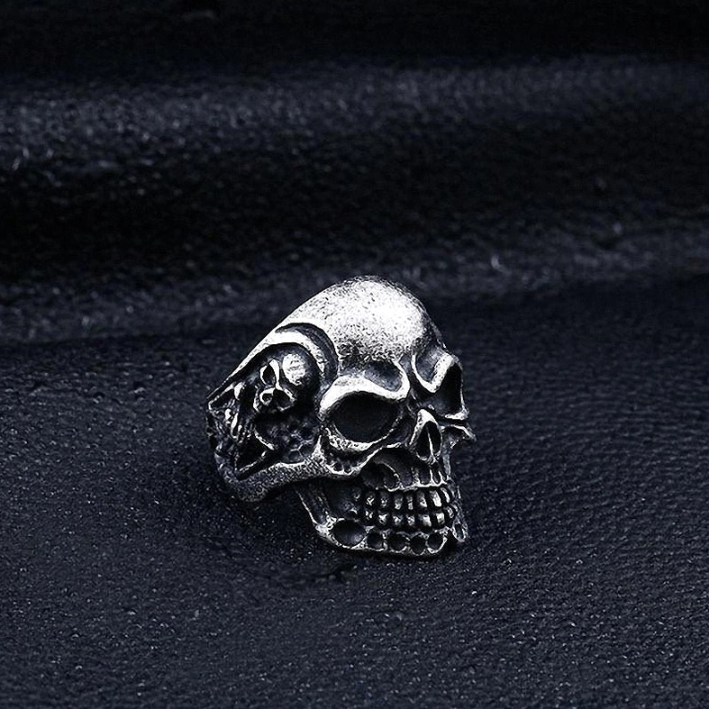 Triple skull gothic ring side-on view displaying ring profile and thickness