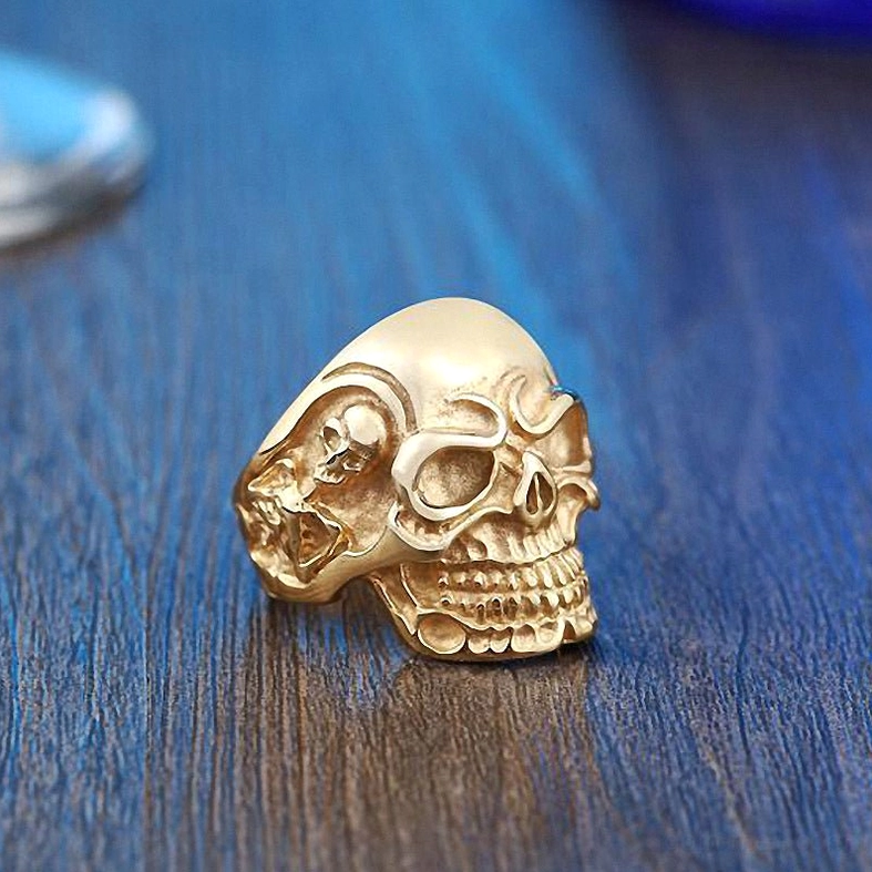 Triple skull gothic ring quarter turn view showing side skull placement