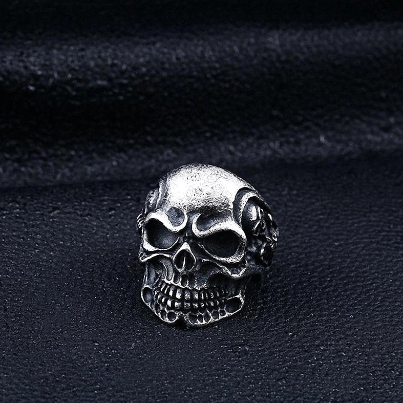 Triple skull gothic ring rotated view showing all three skull faces