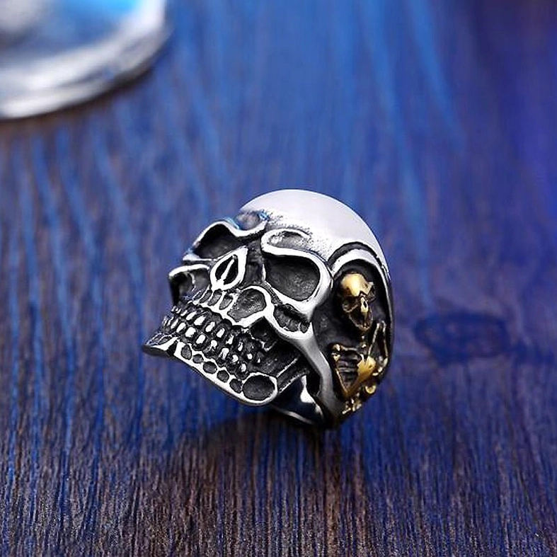 Vintage color triple skull gothic ring overhead flat lay display