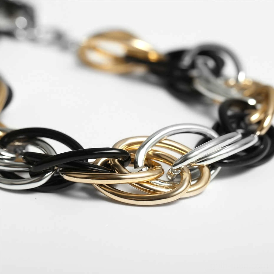 Close-up macro photography of interlocking tri-color twisted chain links showing textured craftsmanship