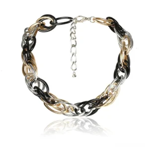 Tri-color twisted curb chain gothic necklace flat lay with metal reflections and adjustable extension