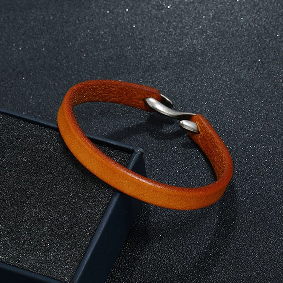 two-tone brown leather cuff bracelet with silver hook clasp on dark background - gothic accessory