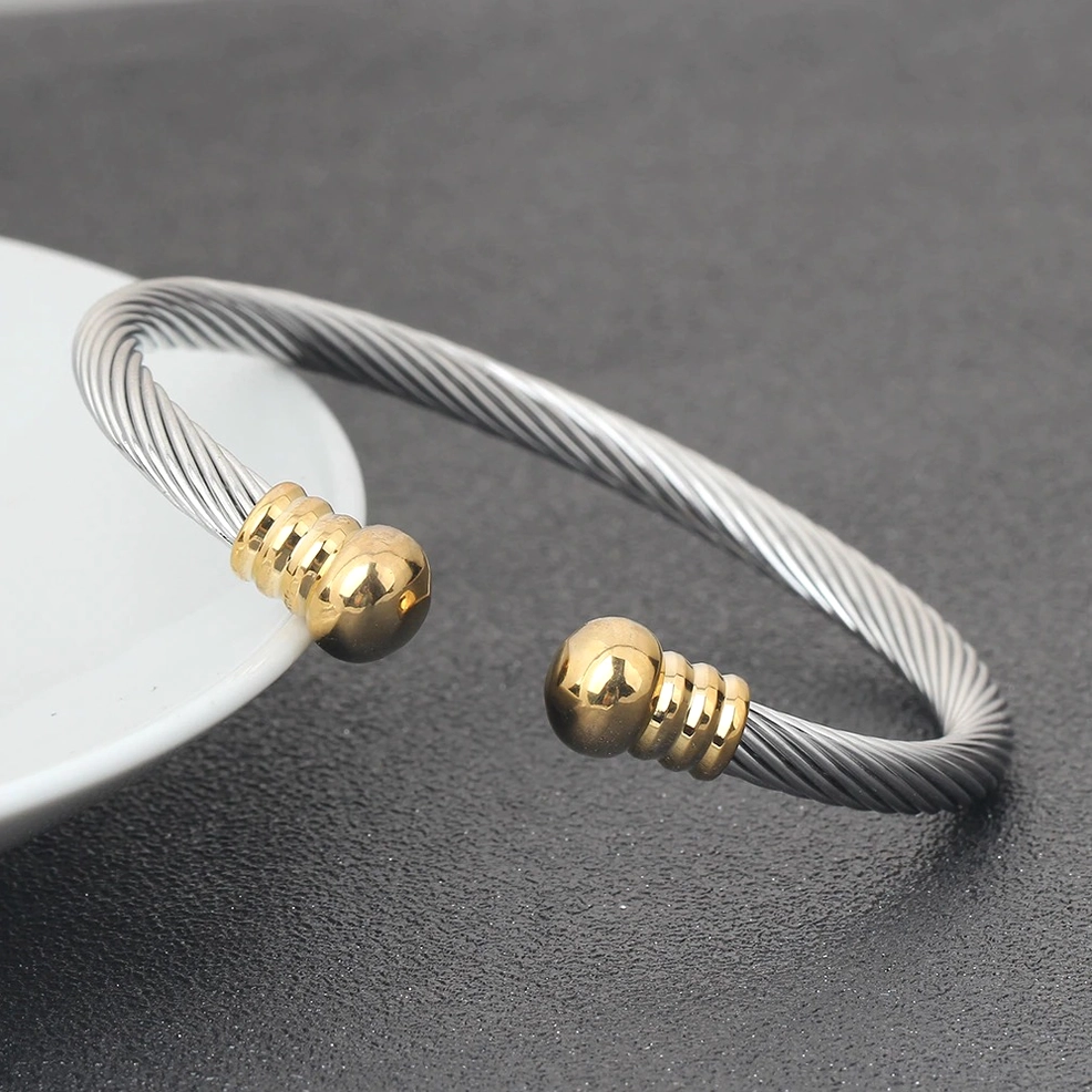Two-tone twisted cable bracelet with gold and silver end caps side view, gothic statement jewelry