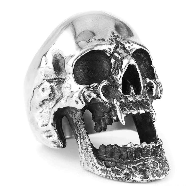 Vampire skull gothic ring with fanged hollow jaw design, overhead close-up view showcasing textured metal surface and intricate skull details on white background